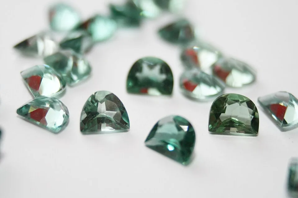 Several faceted prasiolite gemstones in different green shades
